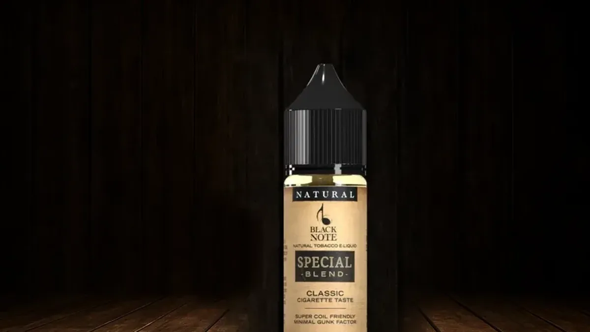 Black Note Special Blend natural tobacco e-liquid, available nicotine-free at 0mg, on dark walnut